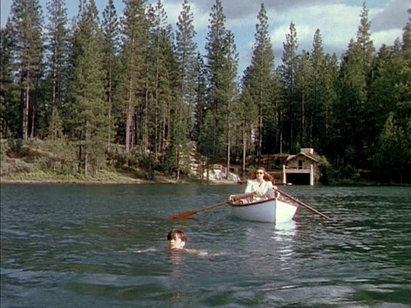 Gene Tierney rows, rows, rows her boat menacingly through the lake in Leave Her to Heaven (Image via Hooked on Houses)
